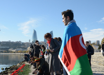 Baku residents bringing flowers to Seaside Boulevard to honor missing oil workers.  Azerbaijan, Dec.07, 2015